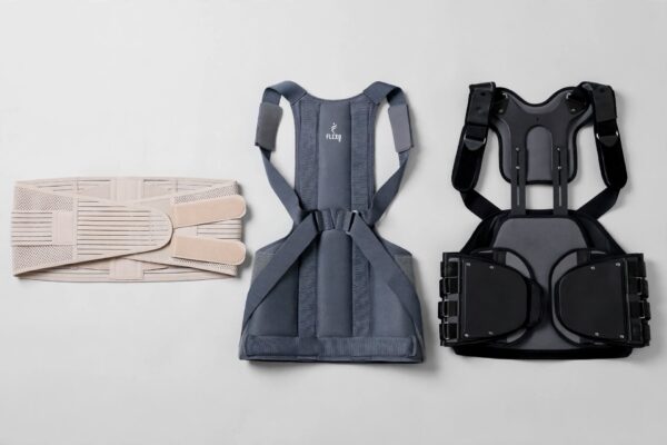 Three types of lower back support belts of increasing rigidity laid out for comparison